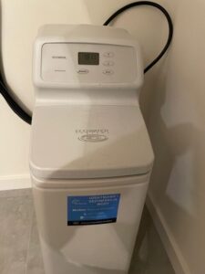 EcoWater water softener with a pressure gauge and pipe connections, a MICHLOR project