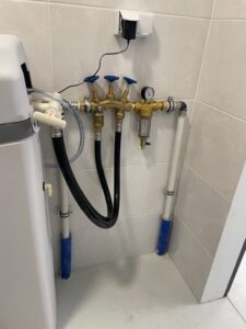 Compact EcoWater water softener in the boiler room of a detached house