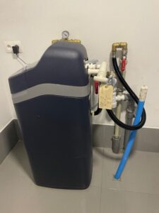EcoWater water softener with a pressure gauge and pipe connections, a MICHLOR project