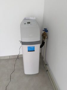 EcoWater water softener with a pressure gauge and pipe connections, a MICHLOR project