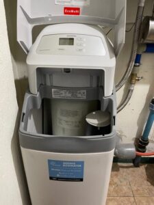 EcoWater water softener with a pressure gauge and pipe connections, a MICHLOR project