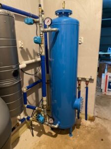 Compact EcoWater water softener in the boiler room of a detached house