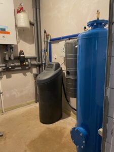 EcoWater water softener with a pressure gauge and pipe connections, a MICHLOR project