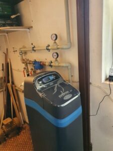 EcoWater softener with the lid open, showing the salt tank