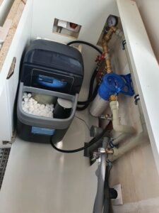 EcoWater softener with the lid open, showing the salt tank