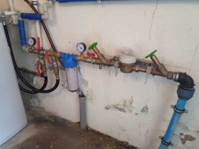 Water filter and EcoWater softener installed in a utility room