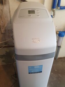 EcoWater softener with the lid open, showing the salt tank