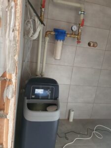 EcoWater softener with the lid open, showing the salt tank