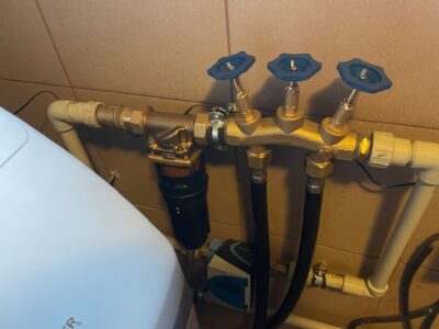 A new EcoWater softener next to the unit being replaced, installed by MICHLOR