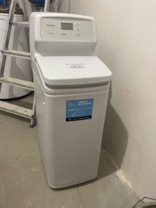 A new EcoWater softener next to the unit being replaced, installed by MICHLOR