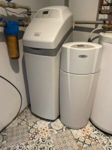 A new EcoWater softener next to the unit being replaced, installed by MICHLOR