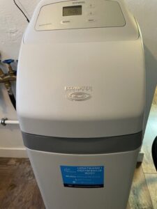 A new EcoWater softener next to the unit being replaced, installed by MICHLOR