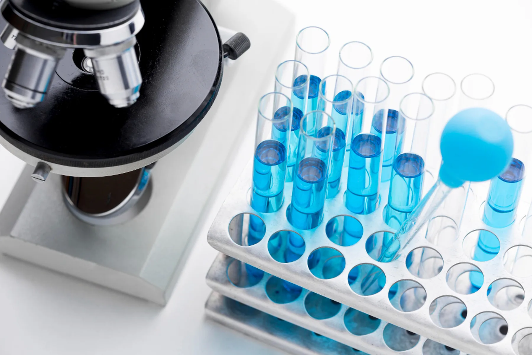 Microscope and test tubes with water samples in an analytical laboratory